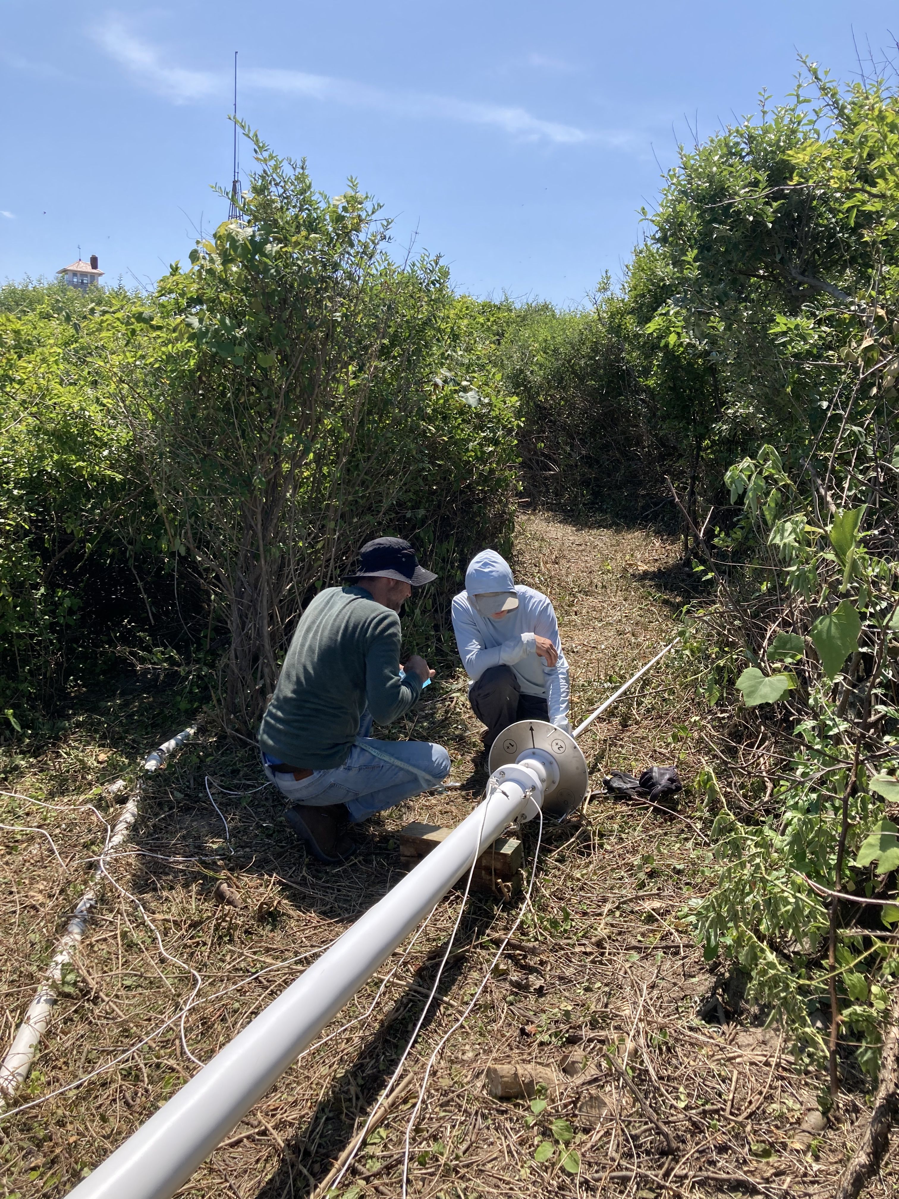 Patrick Pasteris and Tyler Knapp work to install one of the HF radar antennas at the Nauset (NAUS) site in Eastham, MA.